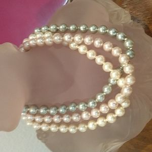 3 strand pearl necklace.  Large pearls.  Each strand a different color.